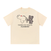 Tierra de Gracia tee in apricot, front view with Venezuela map including hatched Guayana Esequiba, Caracas heart, PlushBerry bear and PLUSHBERRY wordmark