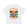 Los Roques tee in white, front view with sunset beach scene, PlushBerry bear in a hammock between palm trees and PLUSHBERRY wordmark